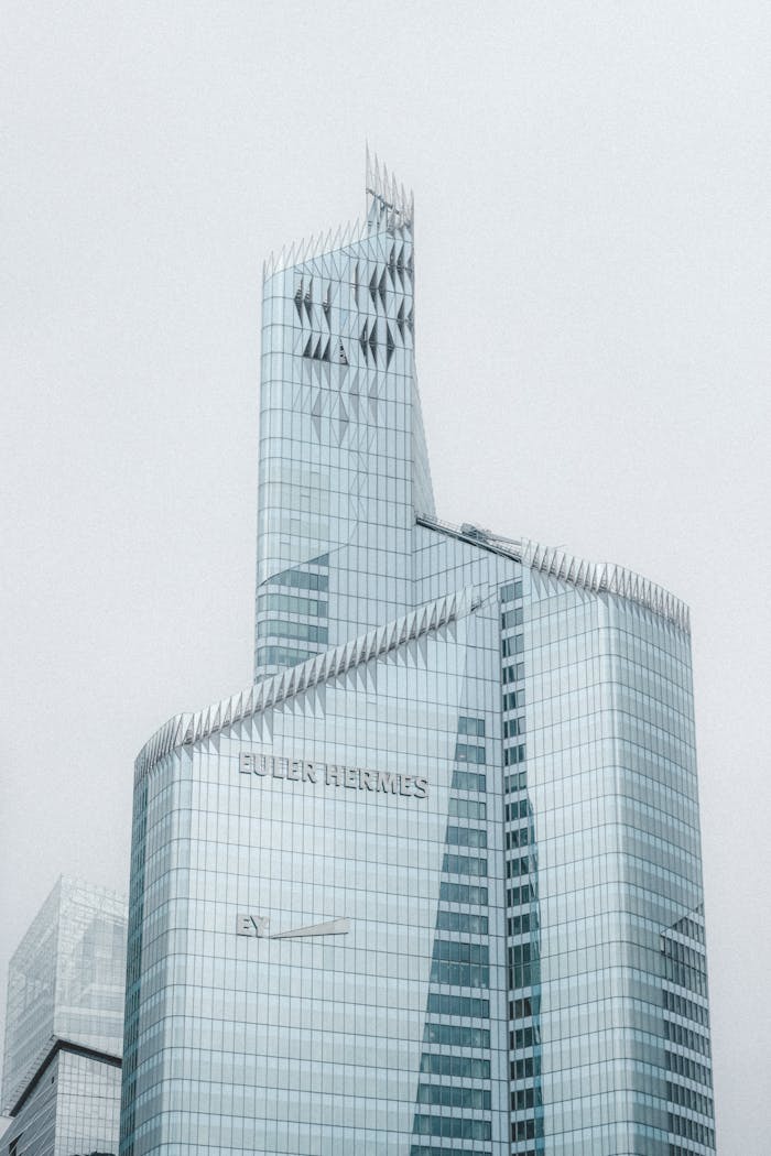 Grey cloudless sky over majestic multi storey modern office building in center of megapolis